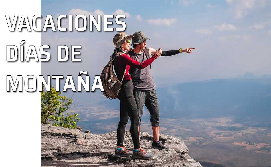 Pareja divisa el paisaje desde lo alto de una montaña